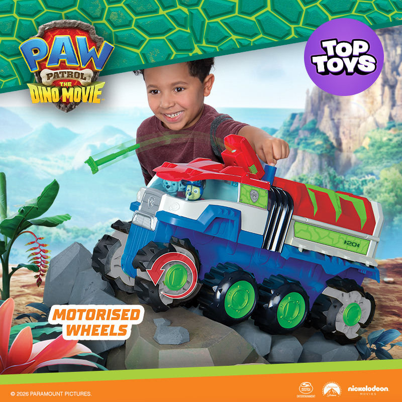 A kid playing with the PAW Patrol: The Dino Movie Ultimate Dino Hauler Motorised Vehicle on a Paw Patrol movie themed background.