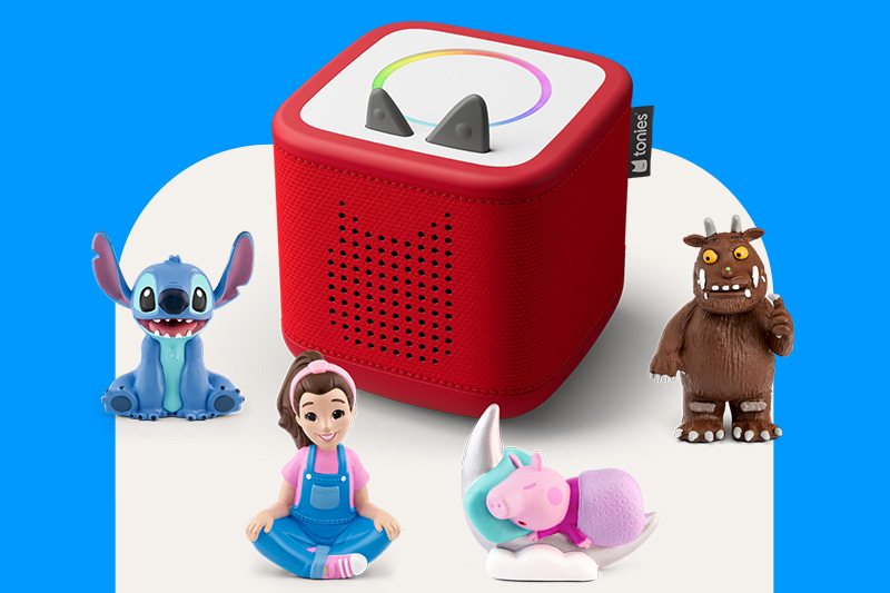 Tonies Red Toniebox Starter Set with Disney Cars Lightening McQueen, Creative Tonie and Paddington Bear Audio Characters in front on a pale pink background