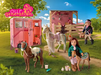 Our Generation equestrian-themed toy scene showing two dolls with horses, a pink horse trailer, a wooden stable, and riding accessories in a sunny outdoor setting.
