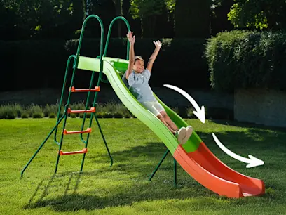 A kid sliding down the 10ft Wavy Slide in a garden.