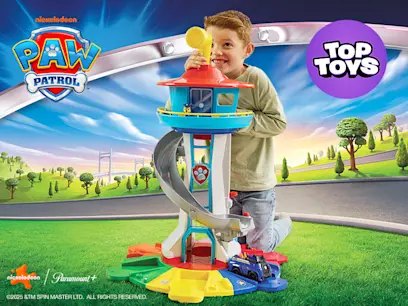 Boy kneeling behind the PAW Patrol My Size Lookout Tower with Vehicle and Figure on a Paw Patrol cartoon background