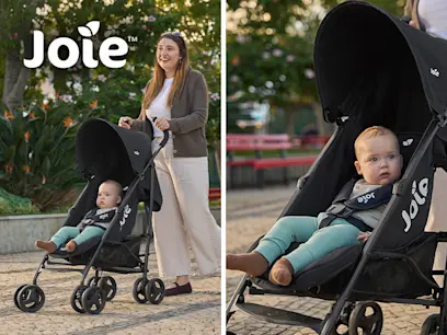 A mum pushing a baby in the Joie Trakker Stroller Black on a footpath.