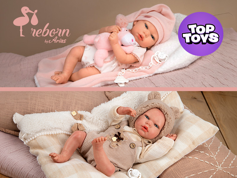 Two lifelike baby dolls with realistic features. The top doll wears pink, holds a plush toy, and has a gentle expression. The bottom doll is in a bear-themed outfit, lying on a soft blanket, looking content.