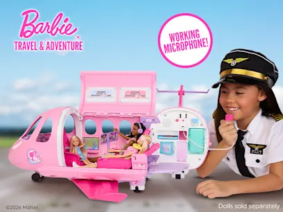 A girl speaking into the microphone for Barbie Dream Plane with an airport background behind her.