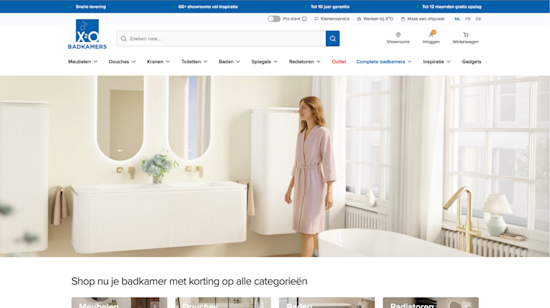 This is a visual of the X2O Badkamers homepage, where the focus is on a serene and modern bathroom setting. The image shows a woman in a light pink bathrobe walking around in her bathroom, surrounded by elegant and minimalistic design elements.