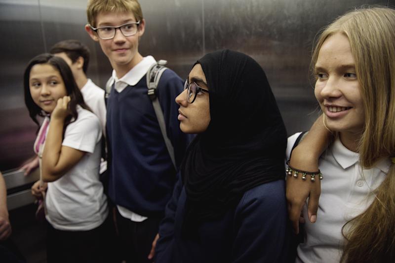 Group of diverse high school students standing together