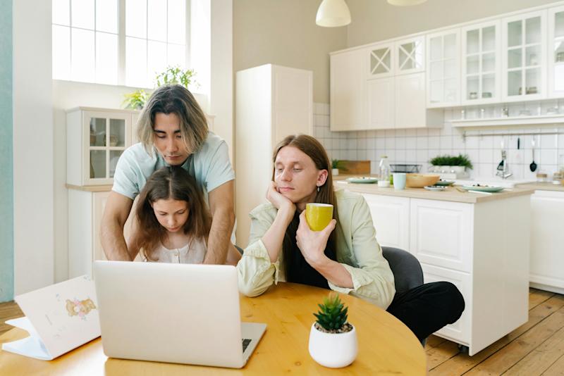 teenage girl on laptop with dads