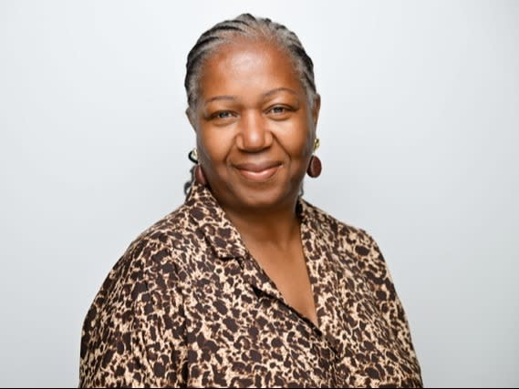 Marjorie James, Chief People Officer at Anna Freud, facing forward, smiling.