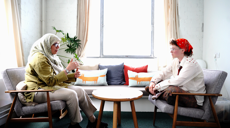 A practitioner sitting face to face with a young person in a therapy session.
