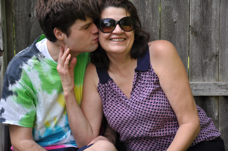 Son kissing his mother on the cheek