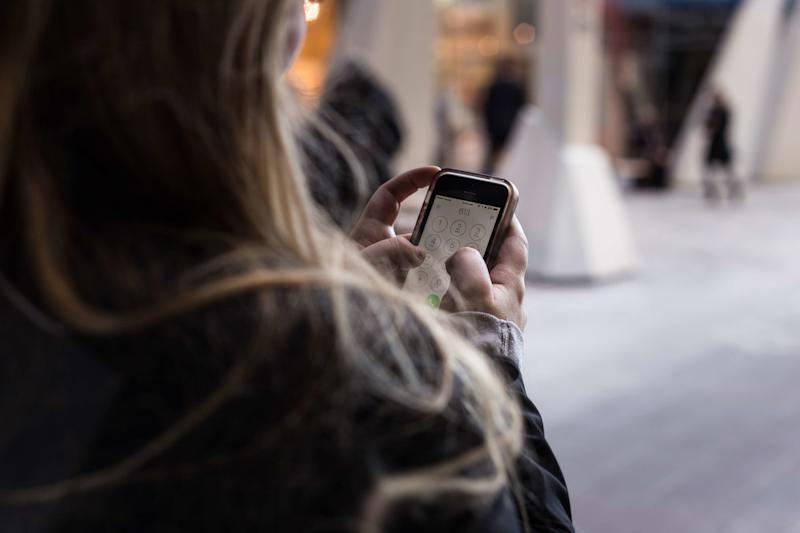 Back view of a woman using a mobile phone.