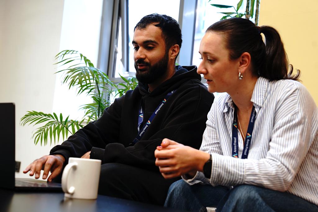 Two students from Anna Freud working together on a laptop.