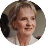 Julia Samuel MBE photographed looking slightly away from the camera smiling.