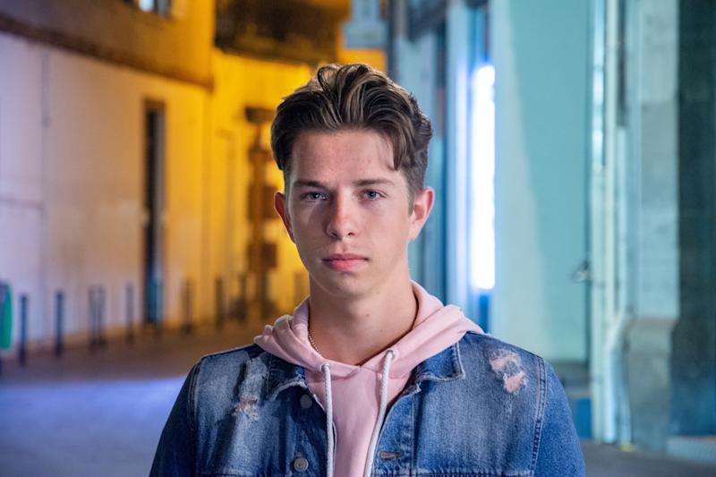 headshot of young male in street at nighttime