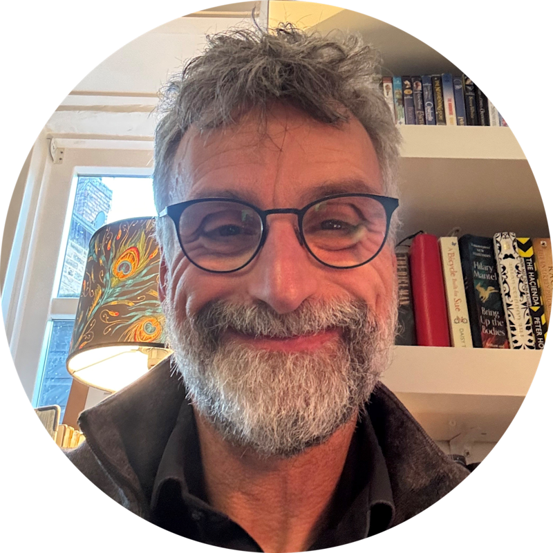 Mark Sampson looking down slightly directly into camera, smiling.