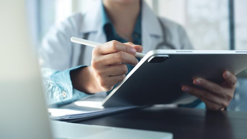Doctor using digital tablet for electronic health records