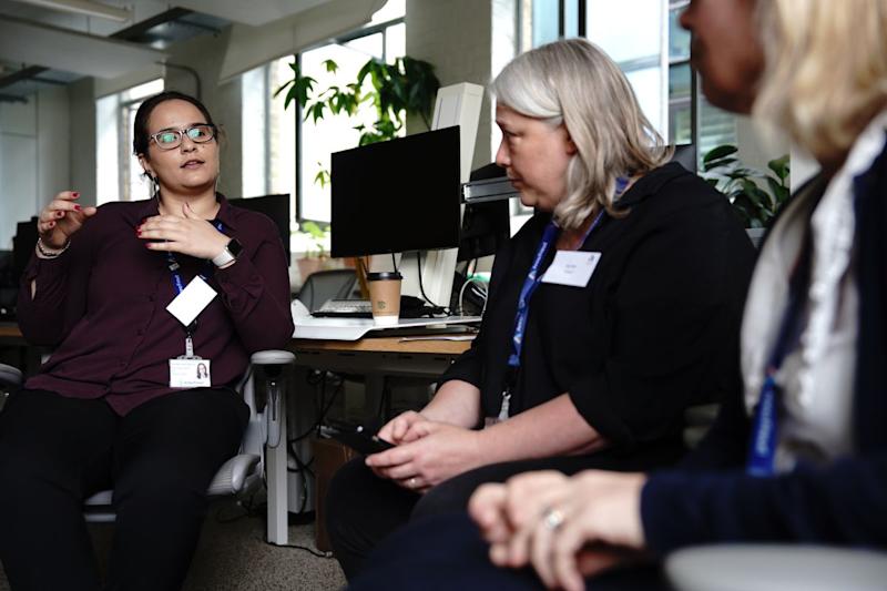 Three Anna Freud staff having a discussion in office.