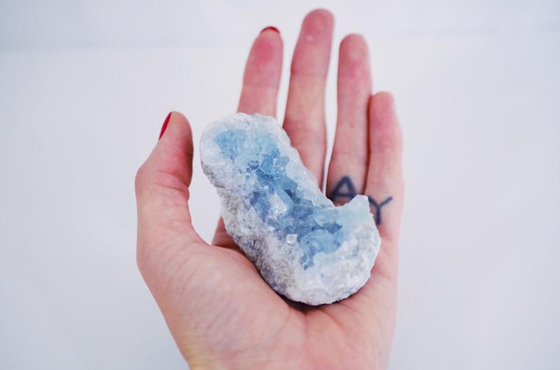 person holding crystal