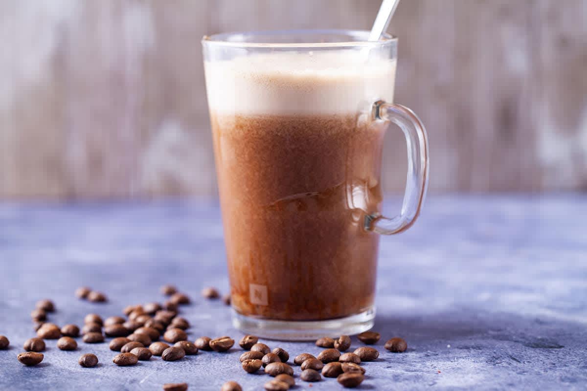 Glass mug with date-sweetened iced latte coffee drink