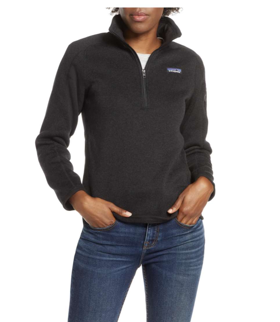 Woman in a black quarter zip sweater