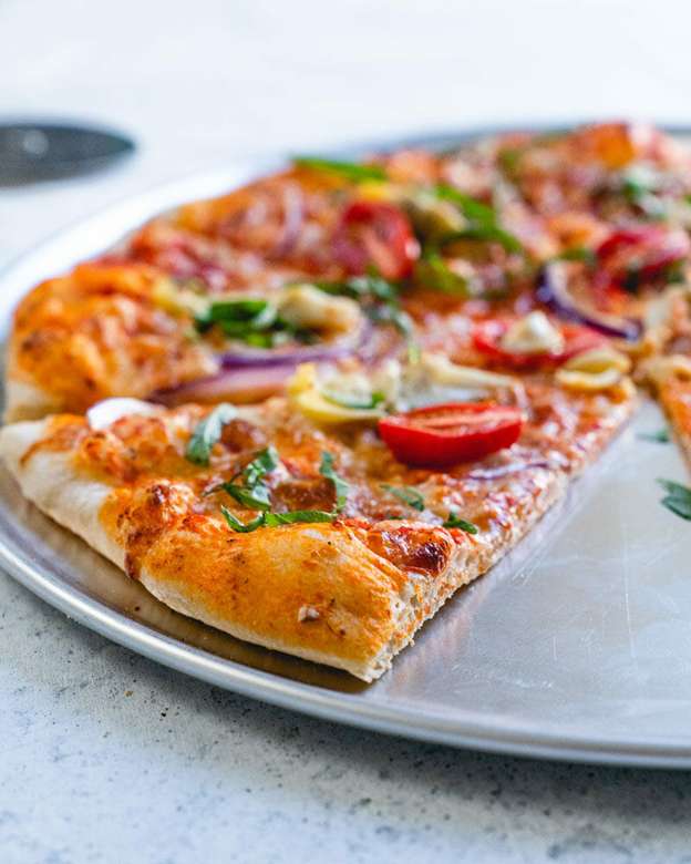Thin crust pizza on a serving tray