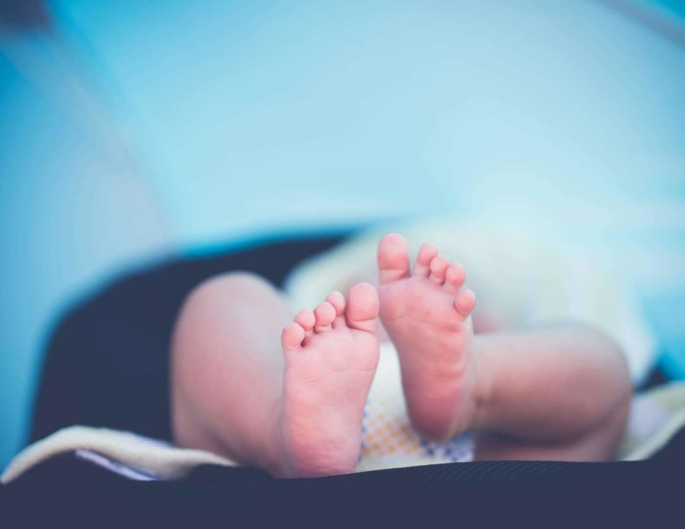 Focus photo of newborn baby feet lying down