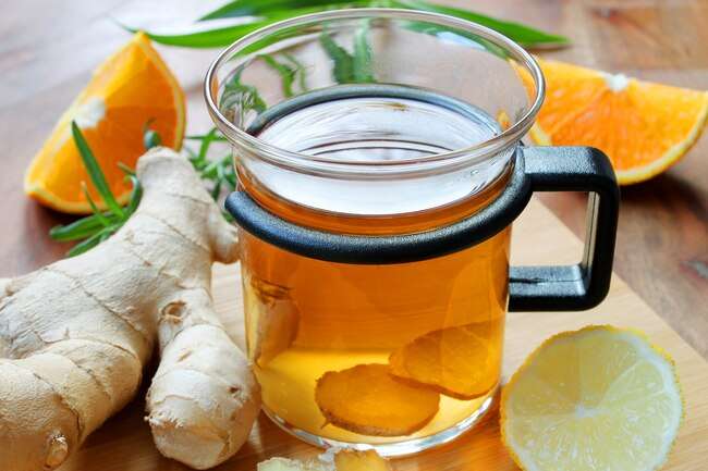 Ginger tea, ginger root and slices of lemon and orange