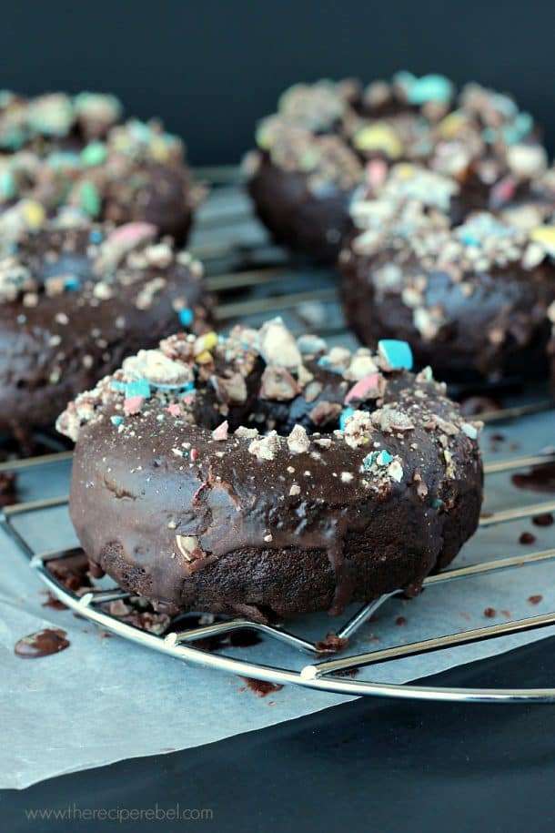 Chocolate doughnuts covered in chocolate glaze and crumbled Robin’s Egg candies.