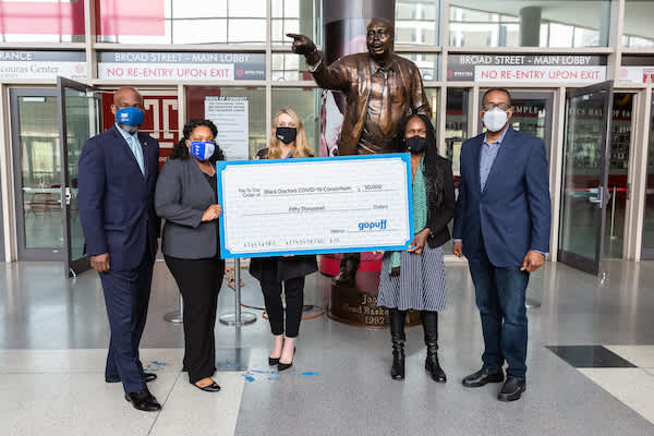 Gopuff presents the Black Doctors COVID-19 Consortium of Philadelphia with a check for their work fighting the pandemic.