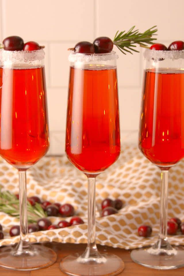 3 champagne flutes filled with cranberry mimosas