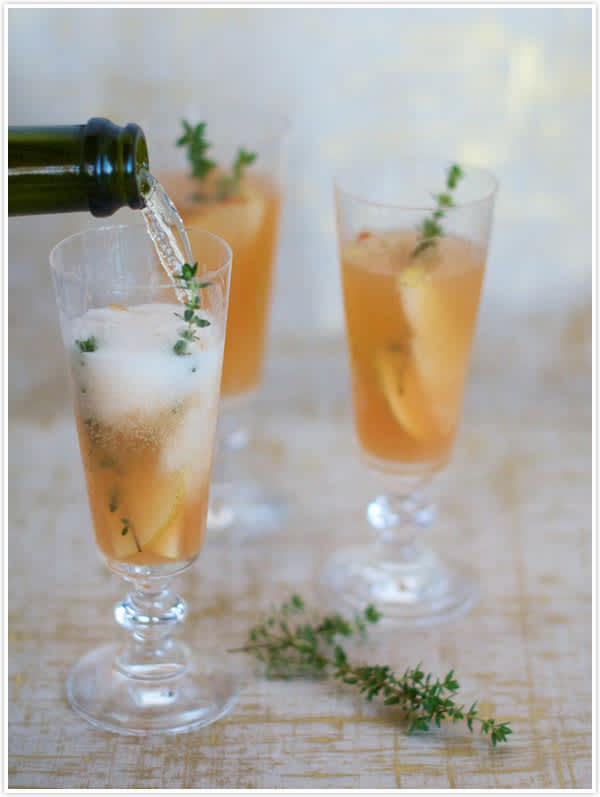 Flute glass with pear & thyme fizz