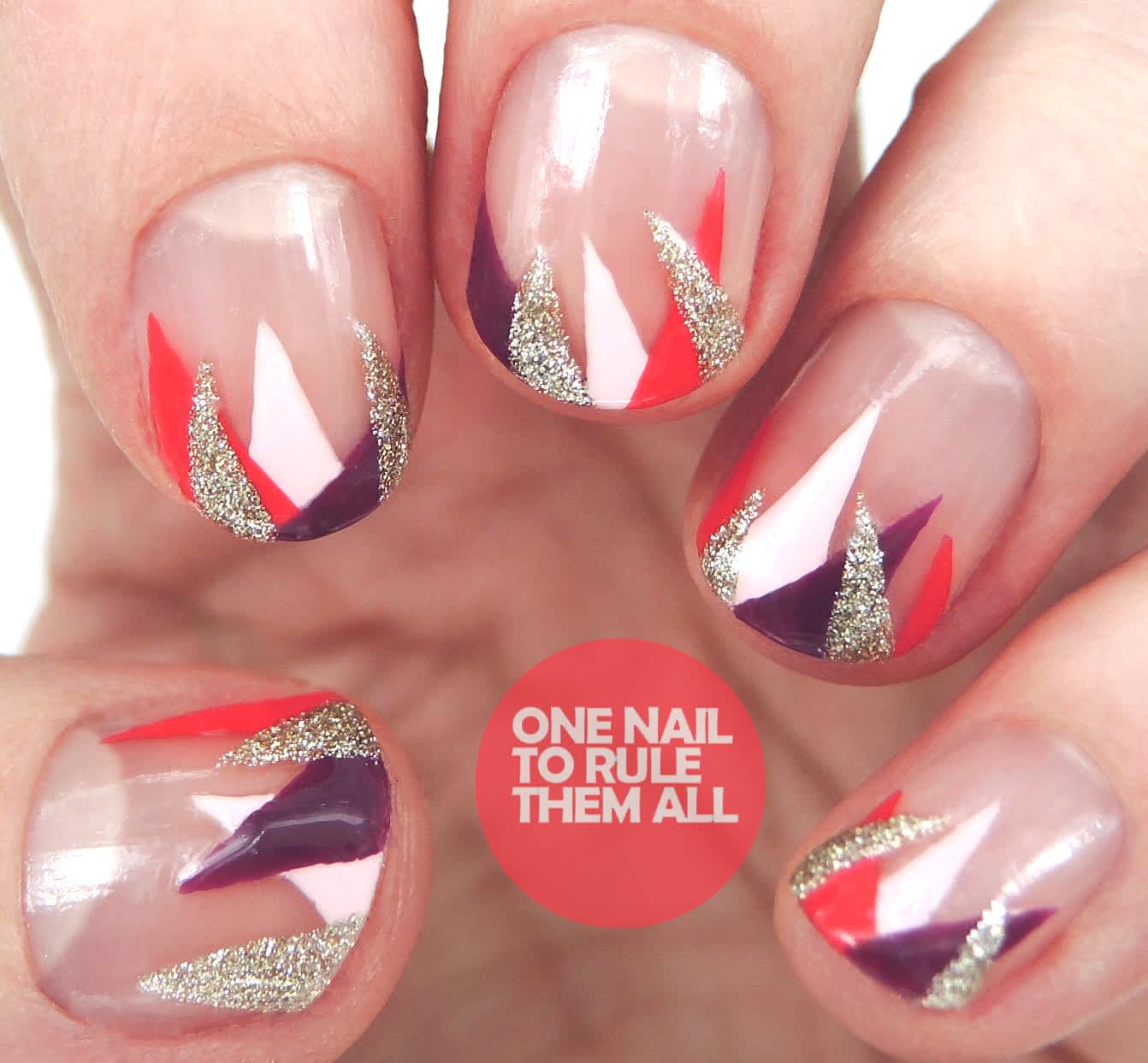 Clear nails featuring triangles of different colors, including gold glitter, white, berry & red