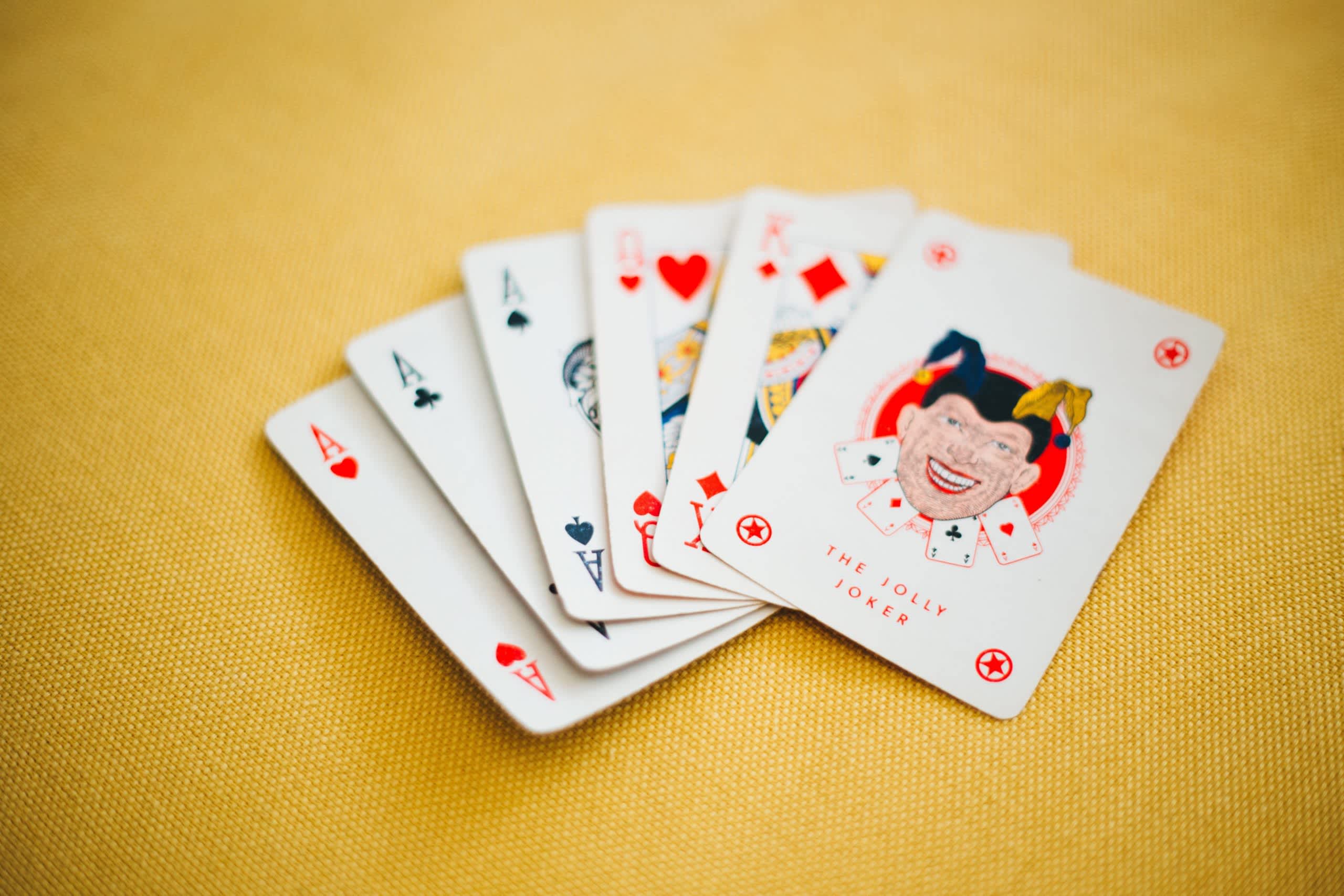 6 playing cards on a yellow background