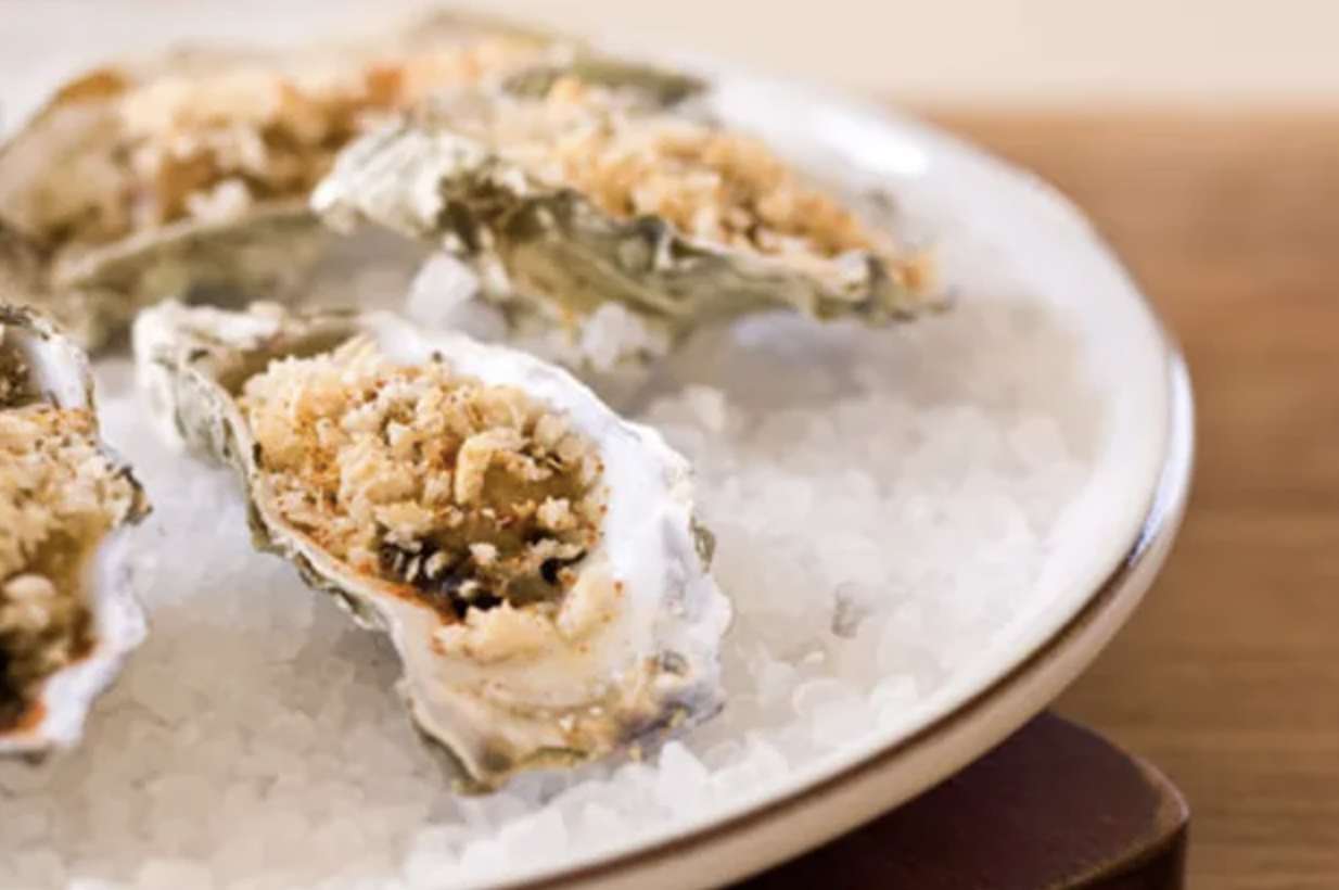 Oysters Bienville served over a plate of ice 
