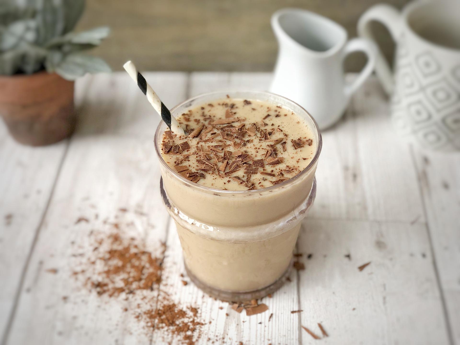 Cappuccino protein shake with straw on it
