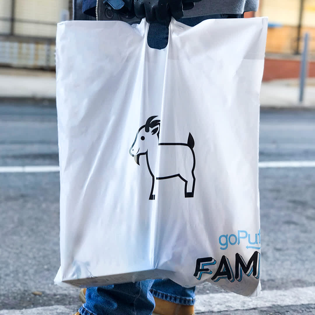 A Gopuff bag with a GOAT logo on the side