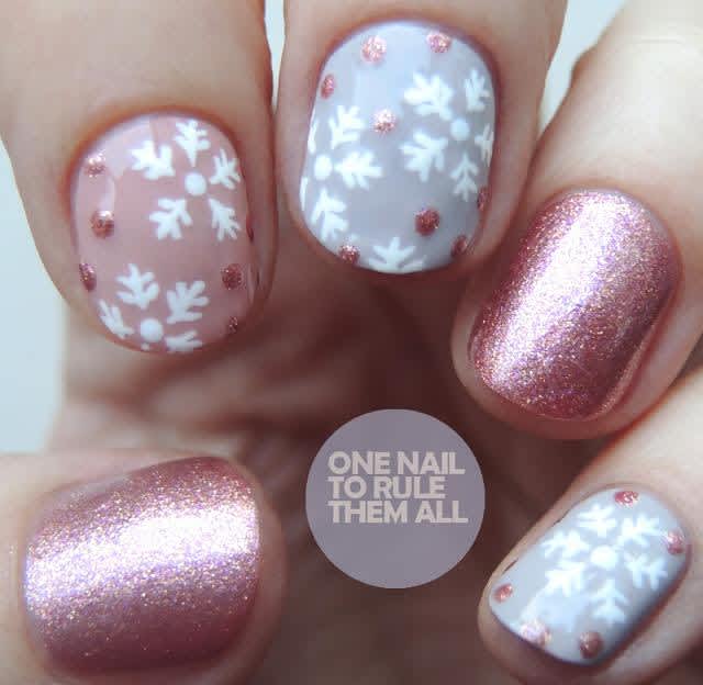 Mauve & gray holiday manicure with assorted nail art, including purple shimmer & white snowflakes  
