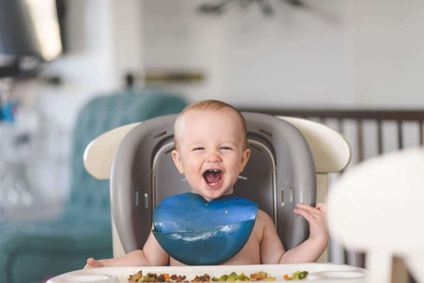 Eight-month old in baby sitting chair eating stage 2 baby food