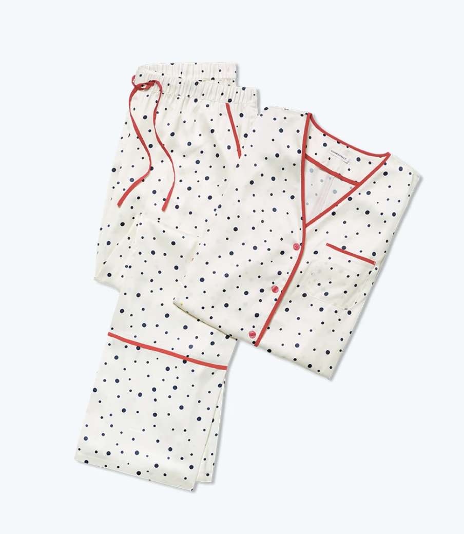 Pair of white pajamas with black polka dots and red trim