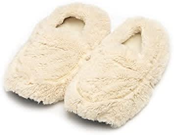 A pair of cream colored slippers