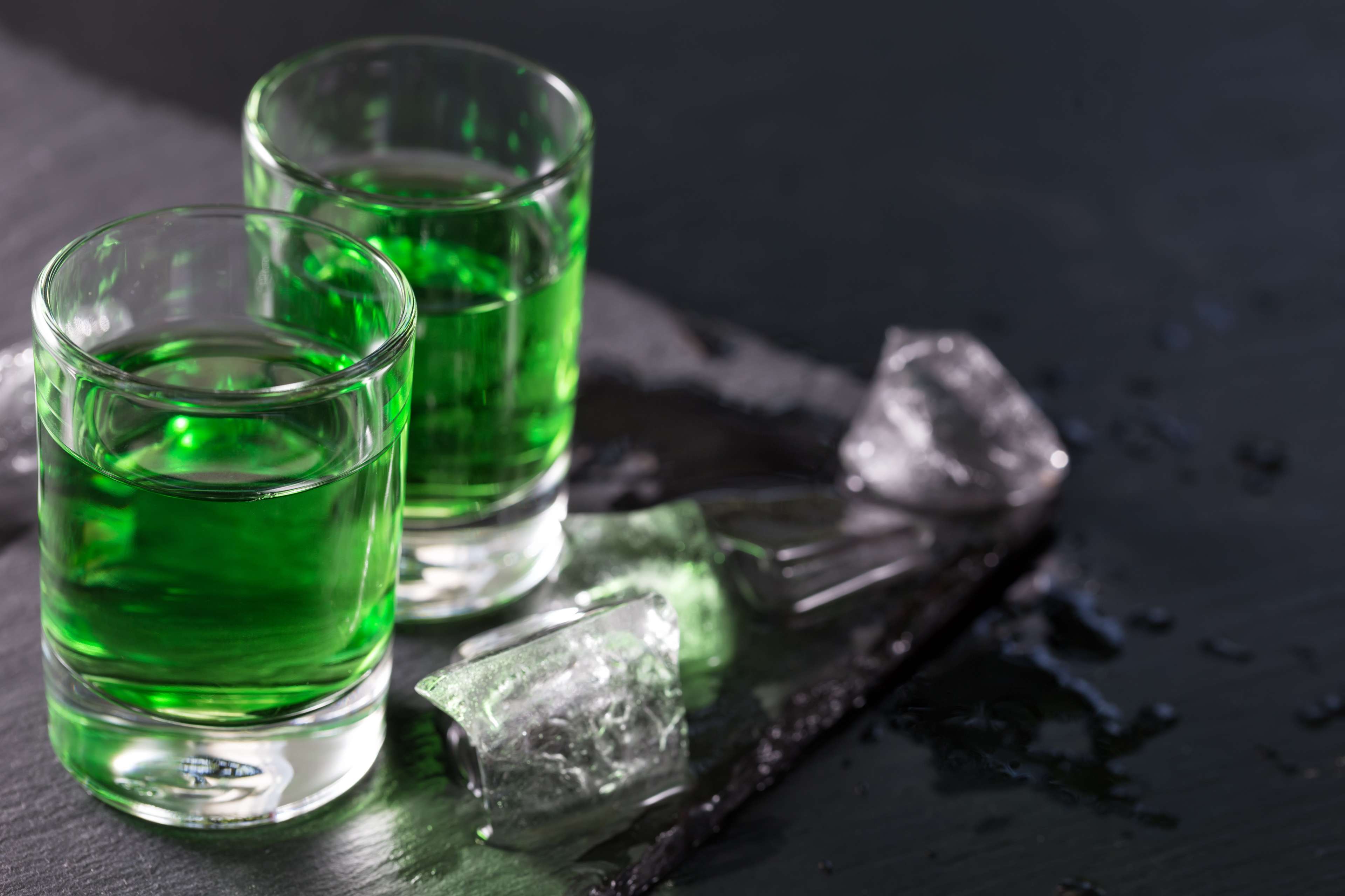 61a9436d426d8e04444b05d2_Two%20glasses%20of%20absinthe%20and%20melted%20ice%20cubes.jpeg