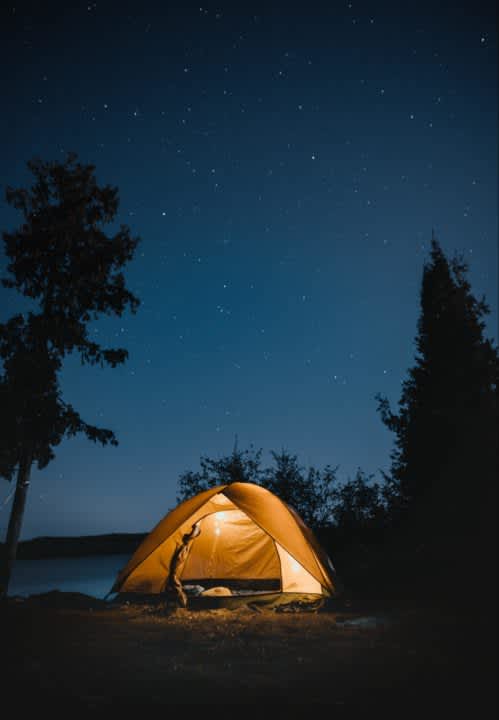 A camping tent at night