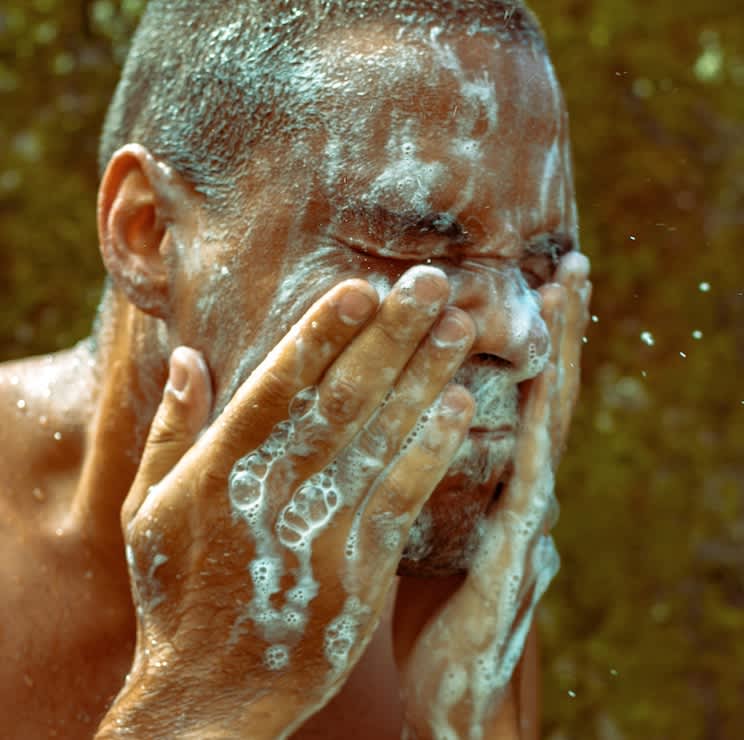 Man using facewash outside
