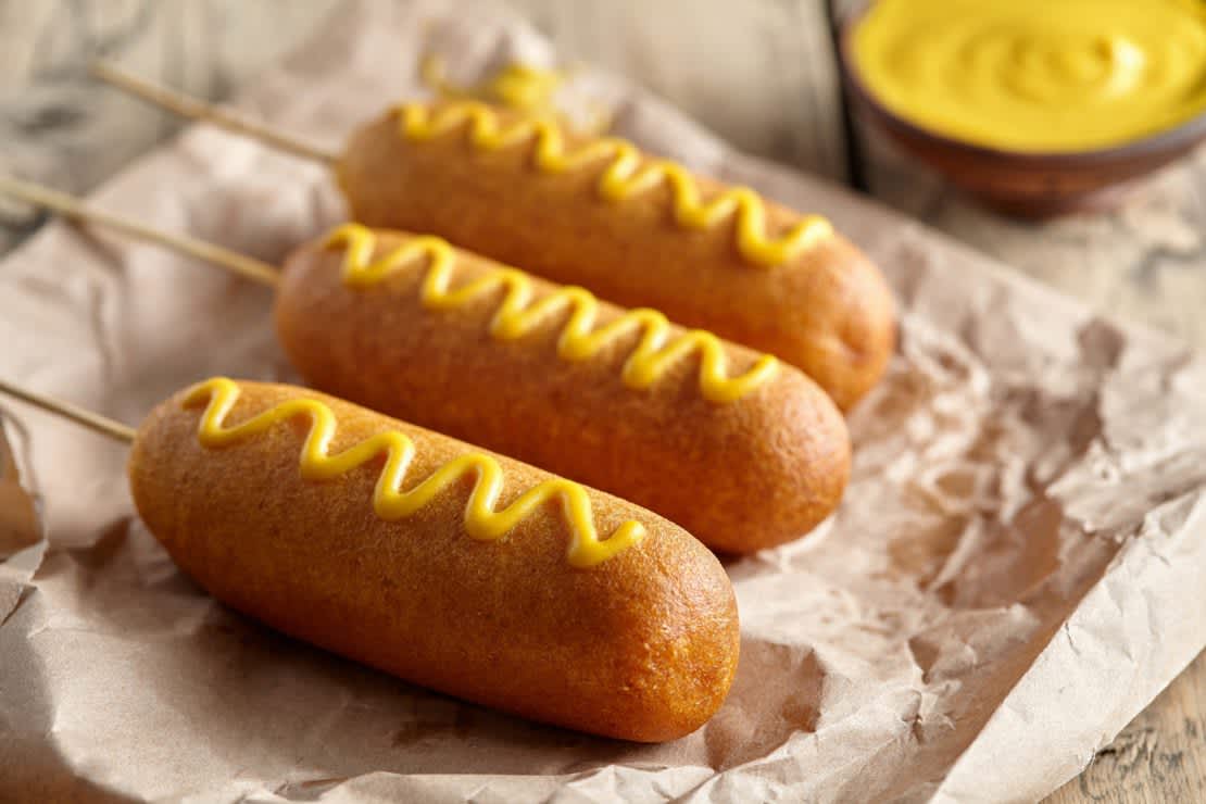 Traditional American corndog, deep-fried hotdog meat sausage with mustard