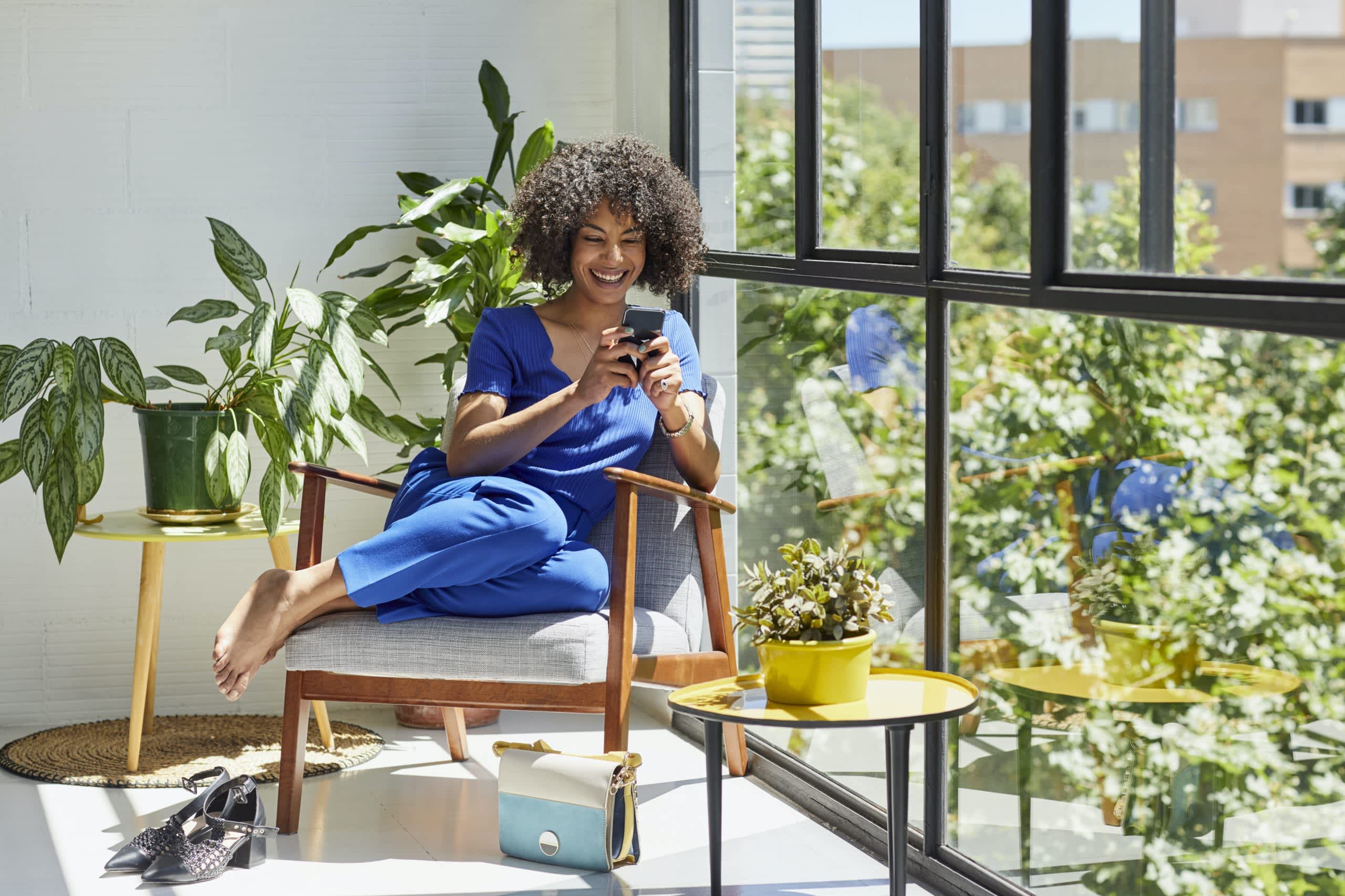 A businesswoman on her phone sitting in a chair