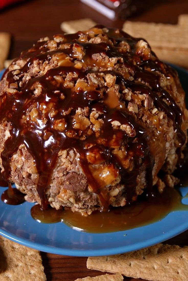 Snickers cheese ball on a serving plate
