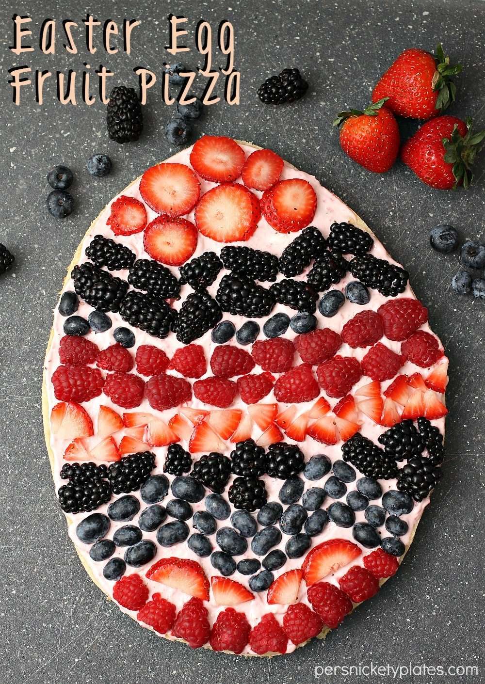 Egg-shaped cookie with cream cheese, raspberries, strawberries, blueberries and blackberries. 