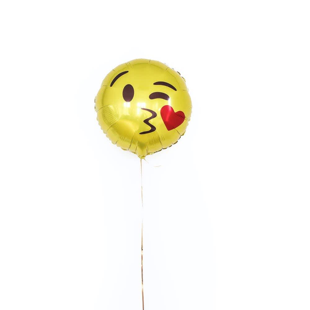 An emoji balloon with a kissy face