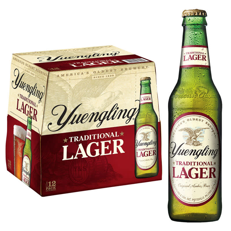 12-pack of Yuengling Traditional Lager bottles next to 1 Yuengling Traditional Lager bottle