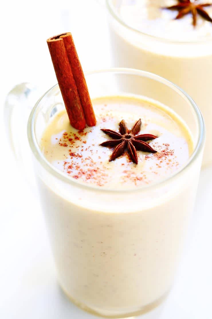 Eggnog with cinnamon stick and cloves 